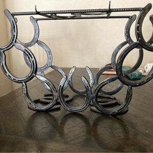 Handcrafted horseshoe wine rack with bar key/wine opener holders on top.